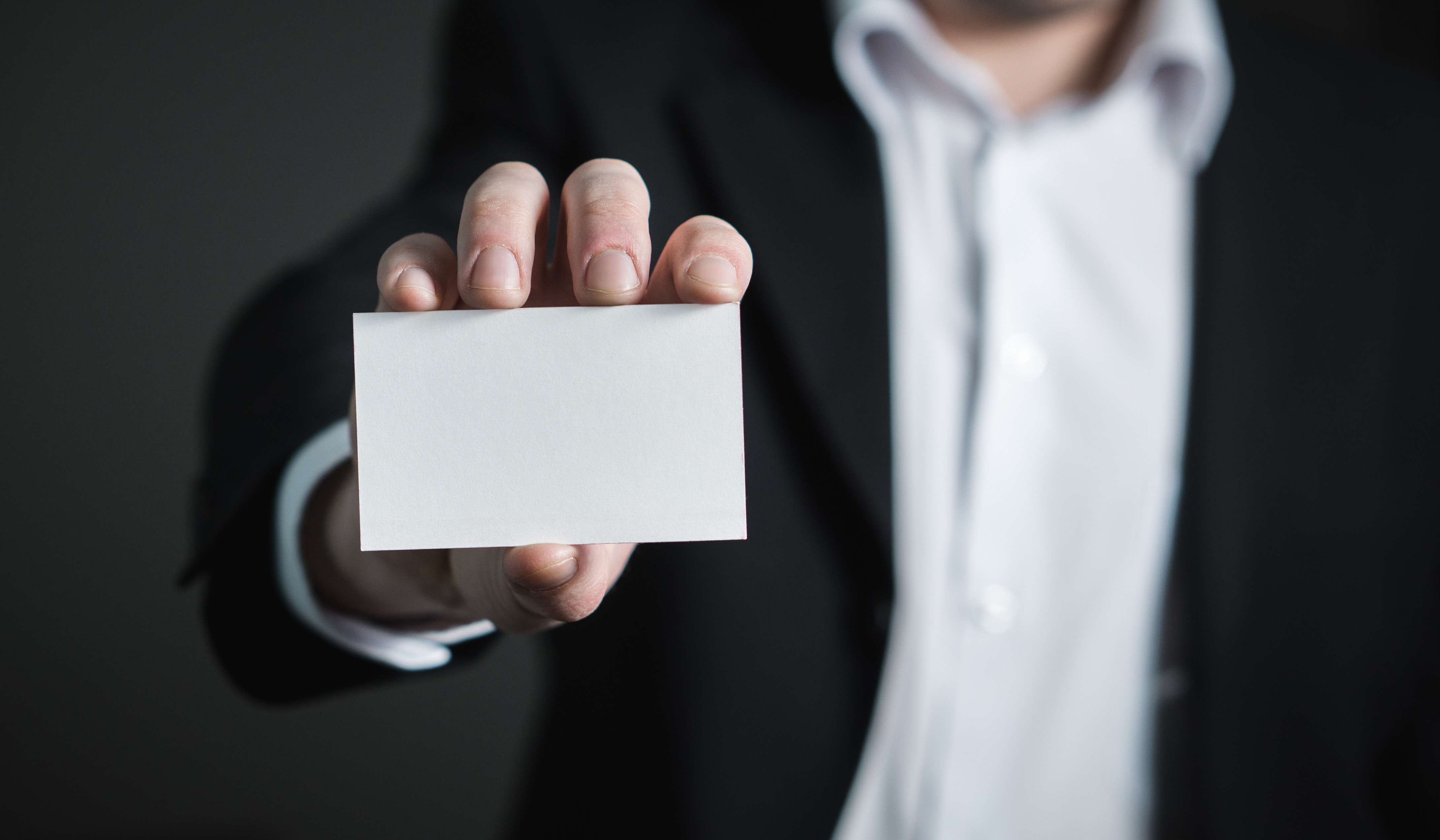 Hand holding blank business card